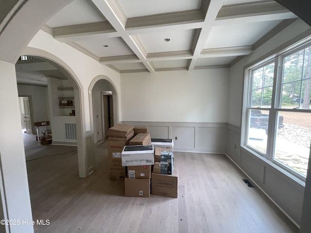 241 Juniper Creek Blvd, Pinehurst, NC 28374 - empty room with arched walkways, light wood-style flooring, beam ceiling, coffered ceiling, and wainscoting