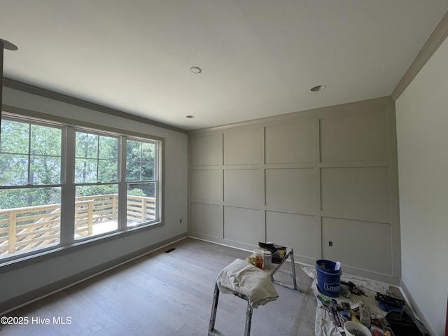 241 Juniper Creek Blvd, Pinehurst, NC 28374 - spare room with a decorative wall, light wood finished floors, baseboards, and crown molding