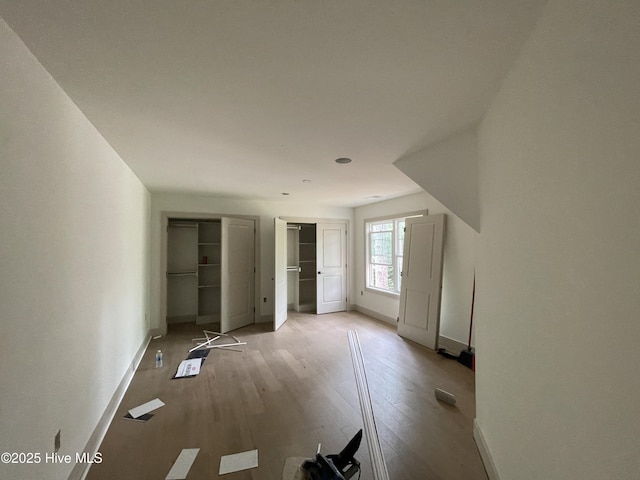 unfurnished bedroom featuring baseboards and wood finished floors