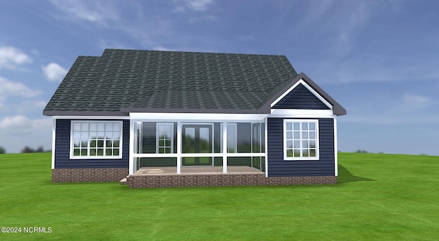 rear view of house with a yard and roof with shingles