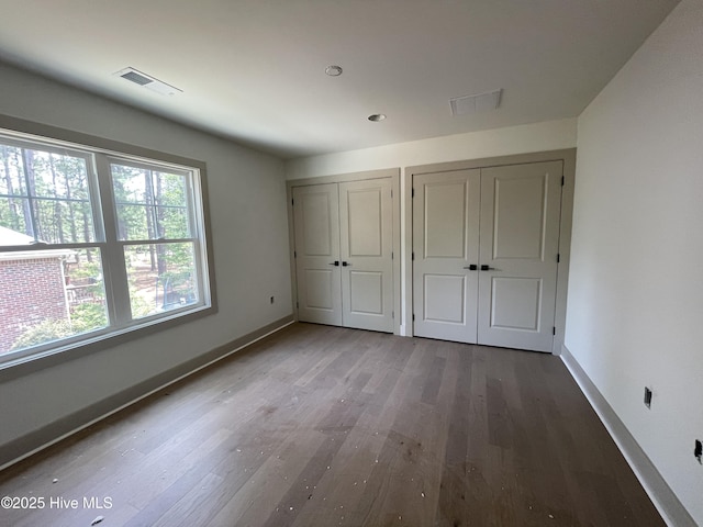 241 Juniper Creek Blvd, Pinehurst, NC 28374 - unfurnished bedroom featuring multiple closets, wood finished floors, and baseboards