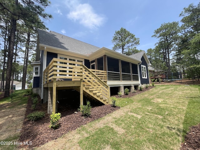 241 Juniper Creek Blvd, Pinehurst, NC 28374 - rear view of house featuring a sunroom, a trampoline, stairs, a yard, and a wooden deck