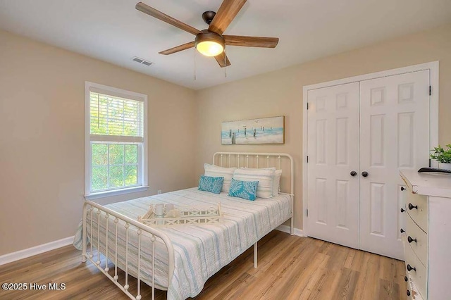 106 NE 62nd St, Oak Island, NC 28465 - bedroom with baseboards, light wood-style flooring, a closet, and ceiling fan