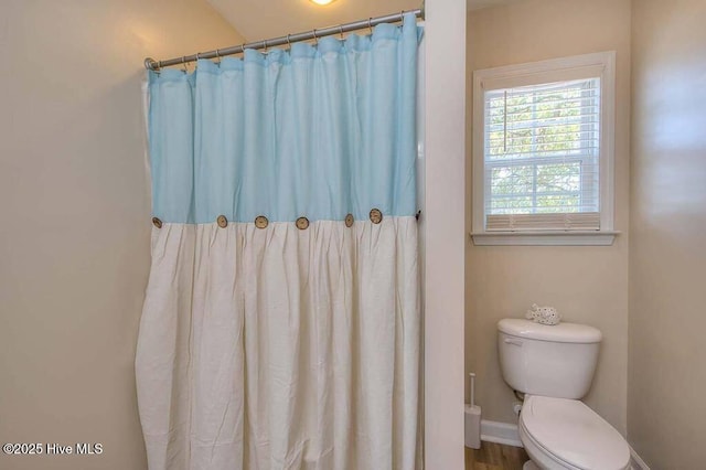 106 NE 62nd St, Oak Island, NC 28465 - bathroom with toilet, curtained shower, and baseboards