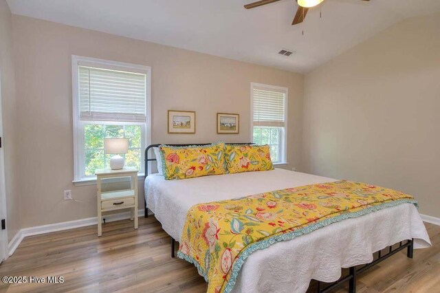 washroom featuring light wood finished floors, laundry area, separate washer and dryer, and baseboards