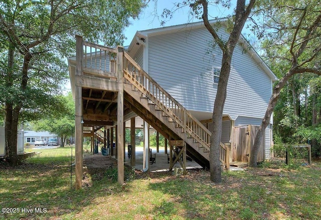106 NE 62nd St, Oak Island, NC 28465 - back of house featuring stairs, a wooden deck, and fence