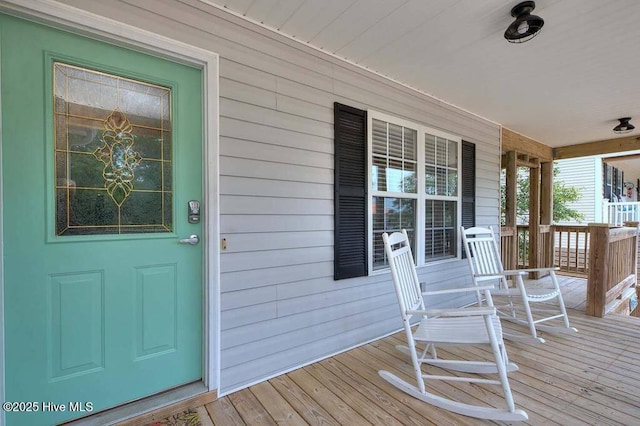 view of exterior entry featuring a porch