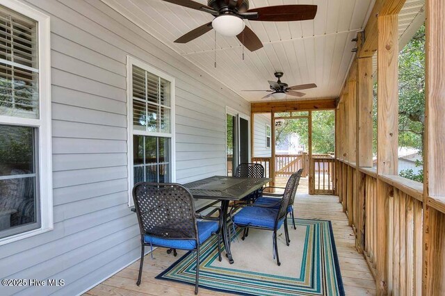 deck featuring outdoor dining area and a ceiling fan