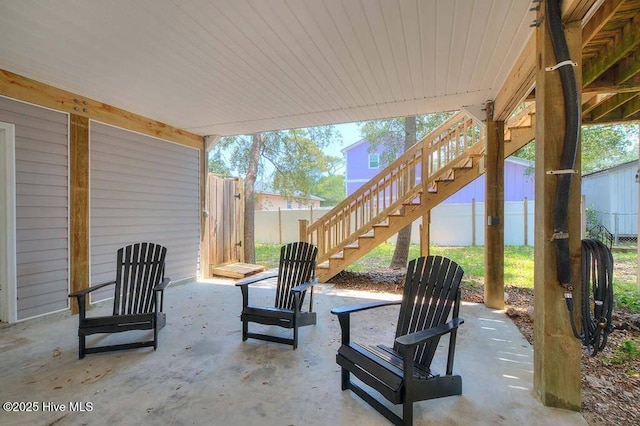 view of patio featuring stairway and fence private yard