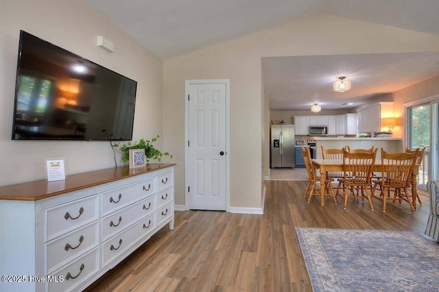 106 NE 62nd St, Oak Island, NC 28465 - dining space featuring vaulted ceiling, light wood finished floors, and baseboards