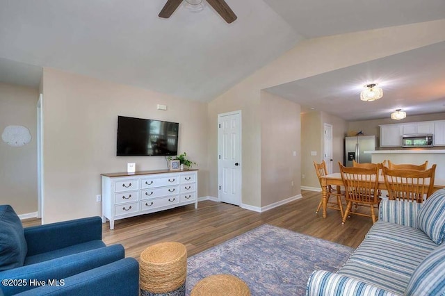 living area with lofted ceiling, dark wood-type flooring, a ceiling fan, and baseboards