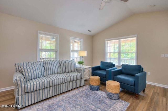 106 NE 62nd St, Oak Island, NC 28465 - living area with plenty of natural light, wood finished floors, ceiling fan, vaulted ceiling, and baseboards