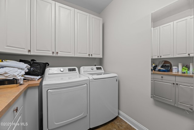 laundry room with cabinets and washer and clothes dryer