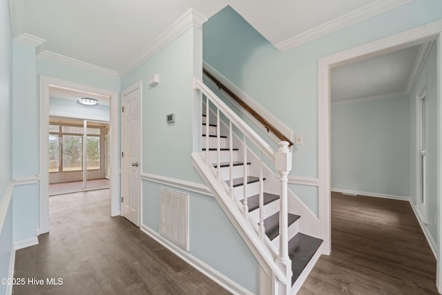 stairs featuring hardwood / wood-style flooring and ornamental molding