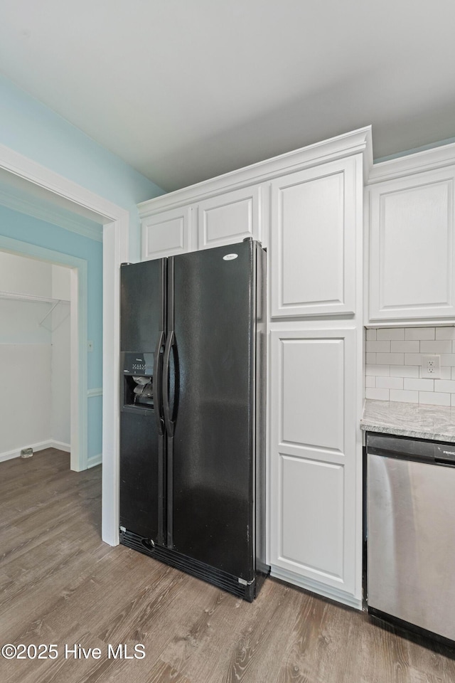 kitchen featuring white cabinetry, black fridge with ice dispenser, dishwasher, and light hardwood / wood-style flooring