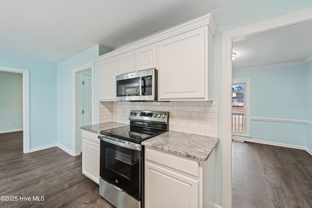 kitchen featuring backsplash, appliances with stainless steel finishes, and white cabinets