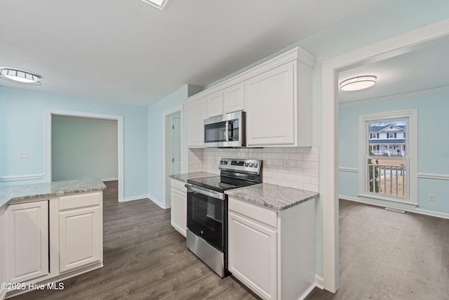 kitchen with white cabinetry, tasteful backsplash, stainless steel appliances, and dark hardwood / wood-style floors