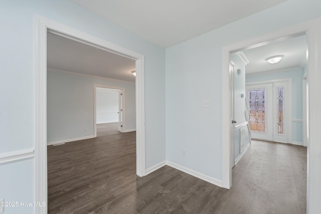 corridor featuring ornamental molding and dark hardwood / wood-style flooring