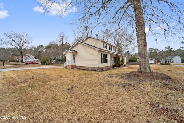 view of side of home with a yard