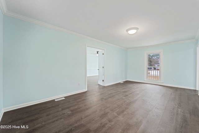 empty room featuring crown molding and dark wood-type flooring