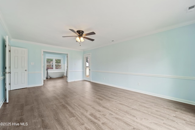 empty room with crown molding, ceiling fan, and light hardwood / wood-style flooring