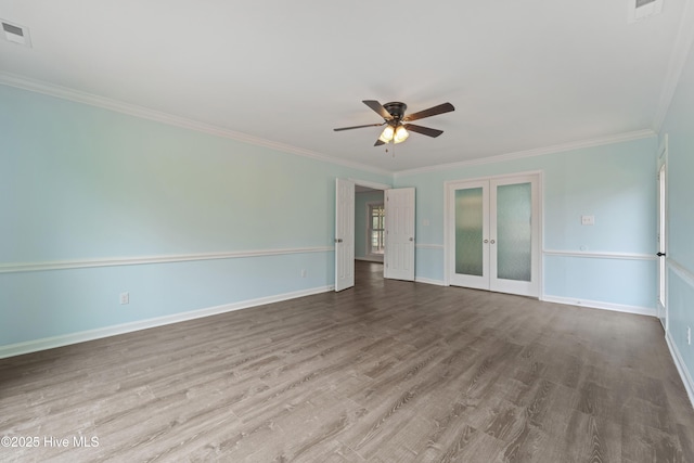 spare room with crown molding, hardwood / wood-style floors, ceiling fan, and french doors