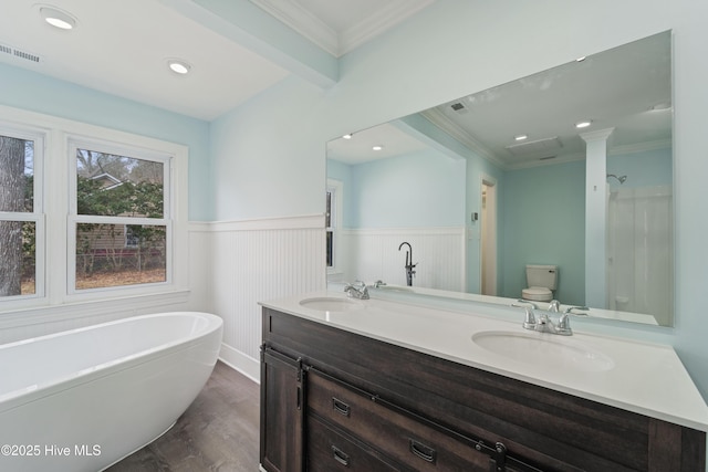 bathroom with vanity, a bath, crown molding, and hardwood / wood-style floors