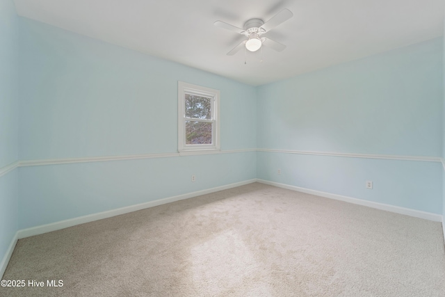 spare room featuring ceiling fan and carpet floors