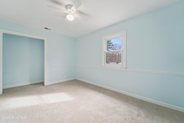 carpeted empty room with ceiling fan