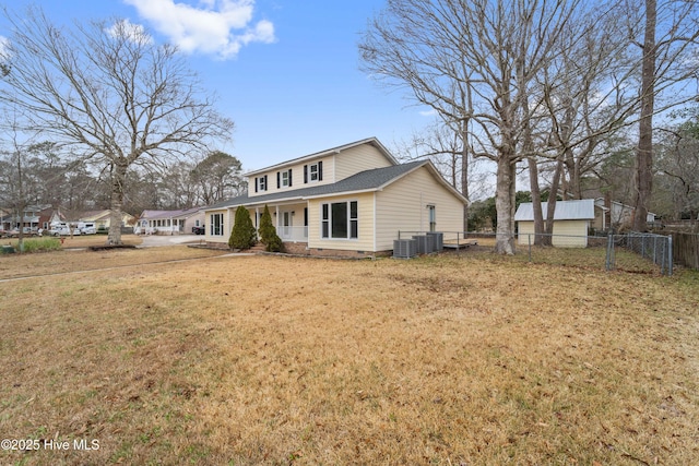 rear view of property with a yard, central AC, and covered porch