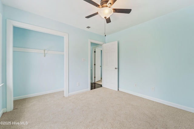 unfurnished bedroom featuring ceiling fan, carpet flooring, and a closet