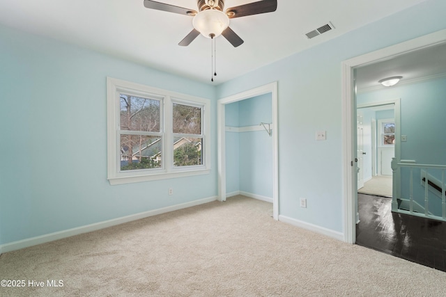 unfurnished bedroom with carpet floors, ceiling fan, and a closet