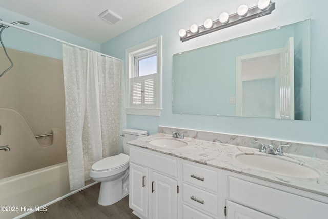 full bathroom with vanity, hardwood / wood-style floors, shower / bath combination with curtain, and toilet