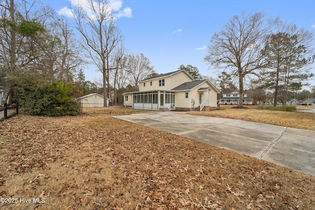 view of front of house with a sunroom