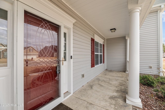 view of exterior entry with a porch