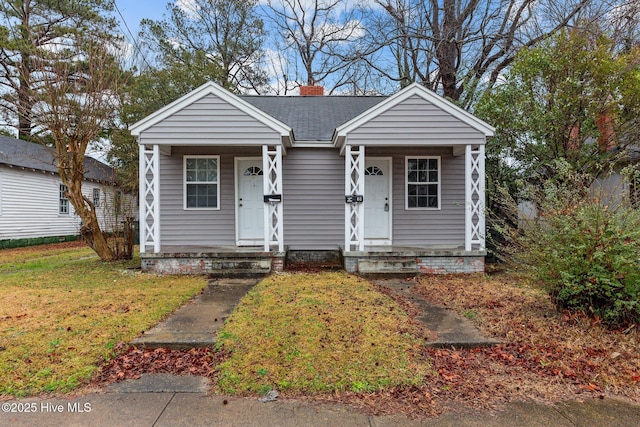 bungalow-style house featuring a front lawn