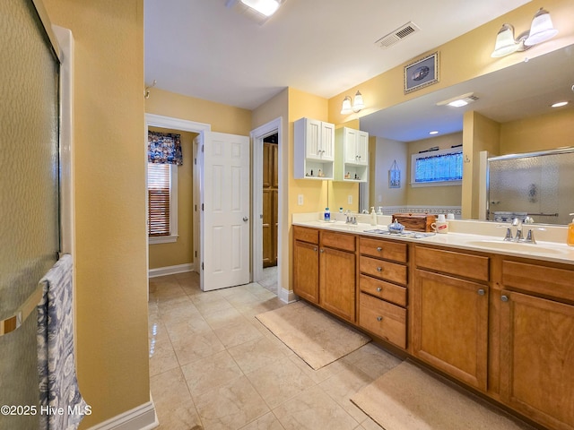 bathroom with vanity and a shower with shower door