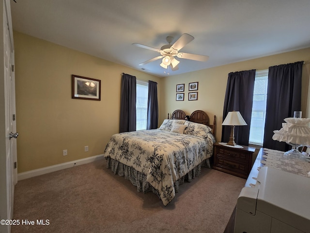 bedroom with multiple windows, ceiling fan, and carpet flooring