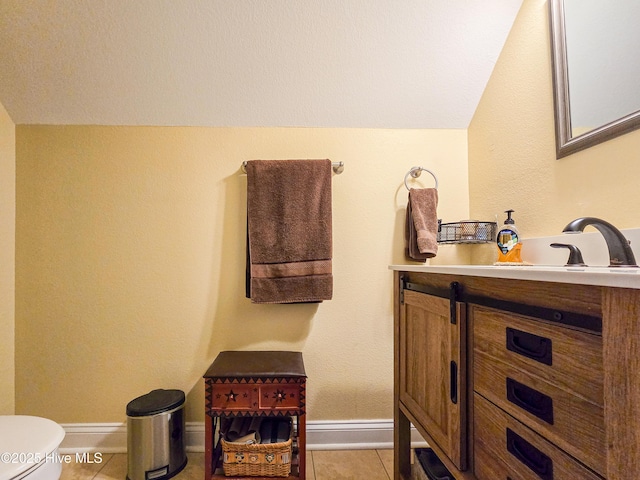 bathroom featuring tile patterned flooring, vanity, and toilet