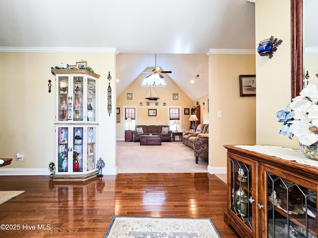 interior space featuring hardwood / wood-style flooring, ceiling fan, ornamental molding, and high vaulted ceiling