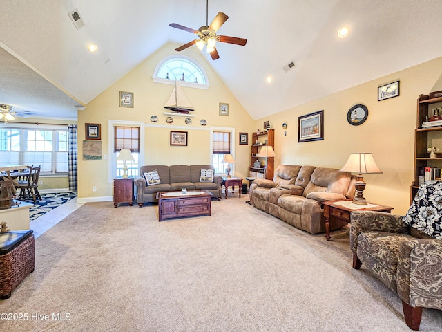 carpeted living room with high vaulted ceiling and ceiling fan