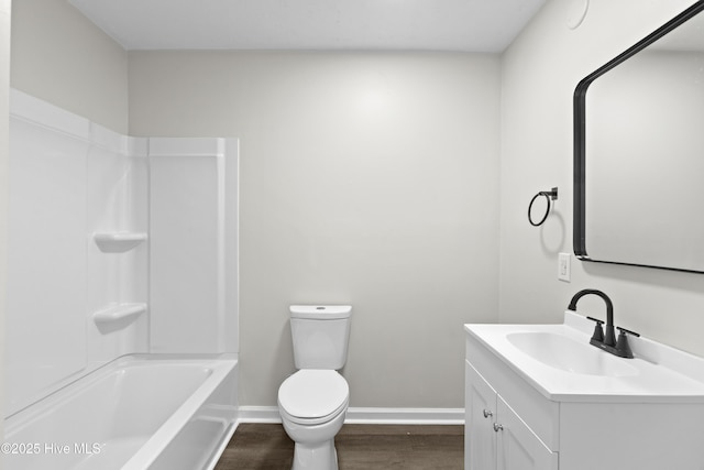 full bathroom featuring shower / bathtub combination, toilet, wood finished floors, vanity, and baseboards