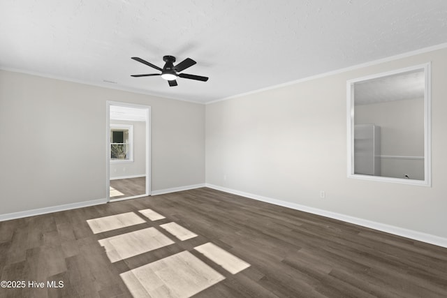 unfurnished room featuring baseboards, ornamental molding, and dark wood-type flooring