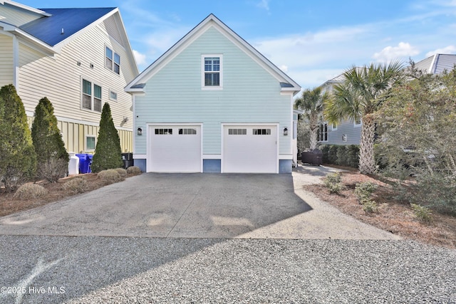 view of home's exterior featuring a garage and driveway