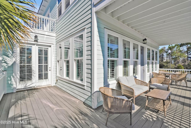 wooden deck featuring outdoor lounge area and outdoor dining space
