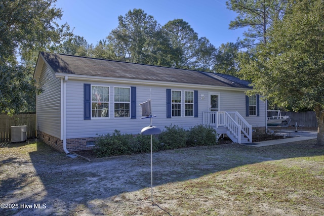 view of front of house with fence, central AC, a front yard, and crawl space