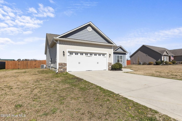 ranch-style home featuring driveway, a garage, stone siding, board and batten siding, and a front yard