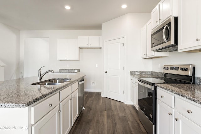 kitchen featuring white cabinetry, an island with sink, appliances with stainless steel finishes, and sink