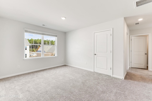 empty room with light colored carpet