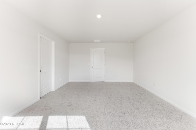 spare room with light carpet